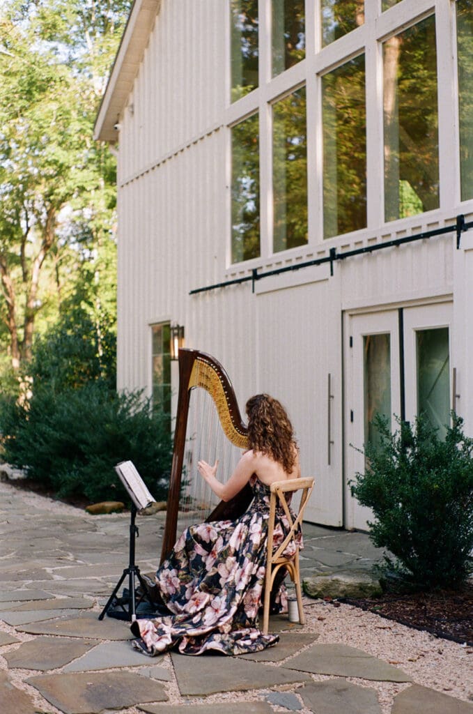 Wedding harpist playing at outdoor ceremony